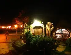 A panoramic view of the Hobbiton movie set, revealing the intricately designed village
