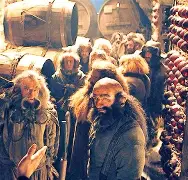 A scene from The Hobbit: An Unexpected Journey featuring Bilbo Baggins, Thorin Oakenshield, and the other Dwarves discussing plans.